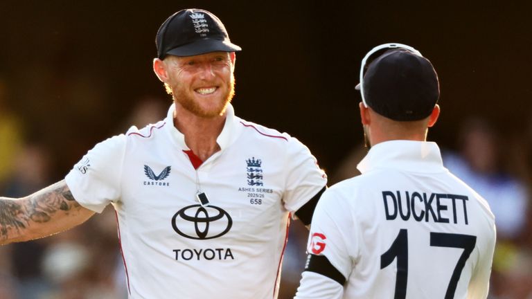 England's captain Ben Stokes celebrates with team-mate Ben Duckett the wicket of Australia's Mitchell Starc during the second Ashes cricket test match between Australia and England in Brisbane, Saturday, Dec. 6, 2025.. (AP Photo/Tertius Pickard)