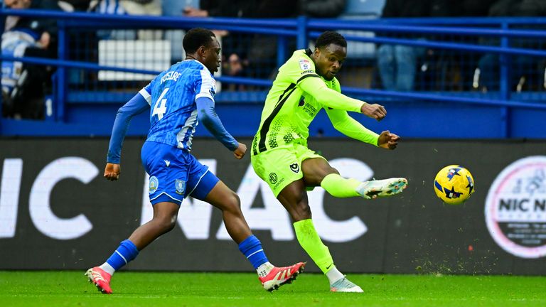 Millenic Alli of Portsmouth crosses the ball while under pressure from Sean Fusire of Sheffield Wednesday